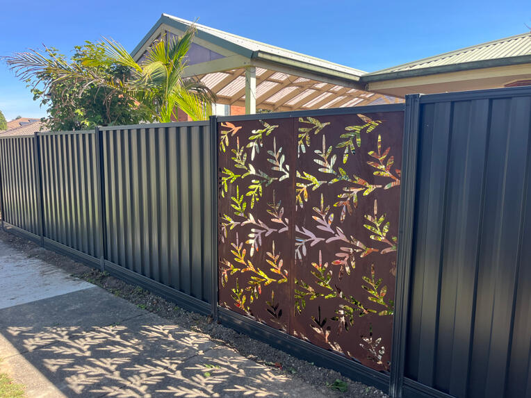Monument Colorbond fence with aluminium sleepers, decorative screening panels and matching side gate. 1.95m high Monument Colorbond front boundary fence with aluminium sleepers, decorative screening panels and side gate completed for an existing home in Beaconsfield.