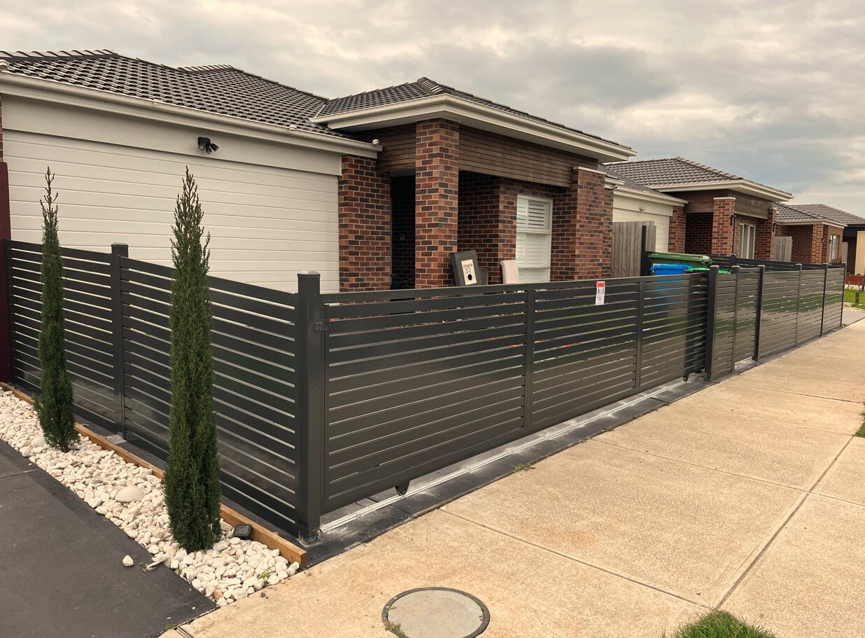 Monument aluminium slat sliding gate with matching pedestrian gate and remote access system. 6m Monument aluminium slat motorised sliding gate with lockable pedestrian access gate and remote control system completed for a repeat customer in Cranbourne East.