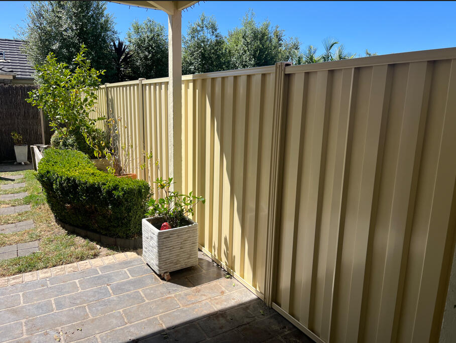 2m high Domain Colorbond privacy fence with timber sleepers completed for a shared boundary fence replacement between existing homes in Narre Warren South.