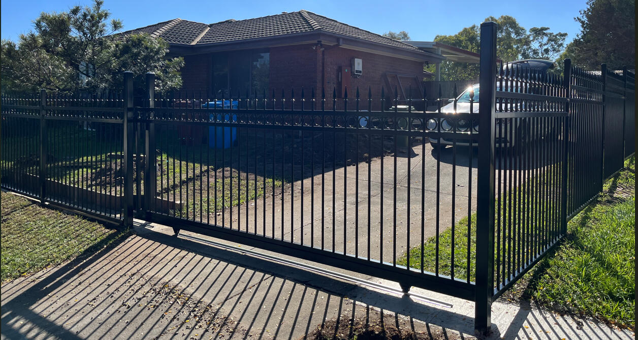 Ring and spear sliding gate with matching front boundary fencing installed in Cranbourne North. Premium 5m wide ring and spear sliding gate completed in Cranbourne North featuring seamless integration with matching front yard fencing for a secure and architectural entrance.