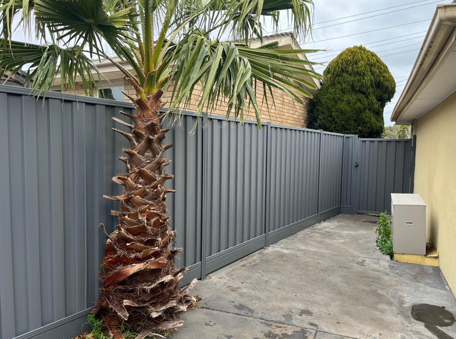 1.95m high Colorbond privacy fence with aluminium sleepers and matching gate completed for a shared boundary in Noble Park North.