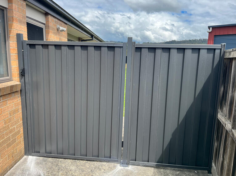 Monument Colorbond side gate with matching fence infill panel completed in Yarragon. 1.2m wide Monument Colorbond side access gate with matching 1m fence extension completed in Yarragon for improved backyard access and functionality.