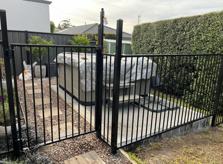 Custom pool and spa fencing completed in Pakenham featuring extra-high posts, child-lock gate system and secure safety enclosure for a residential outdoor area.