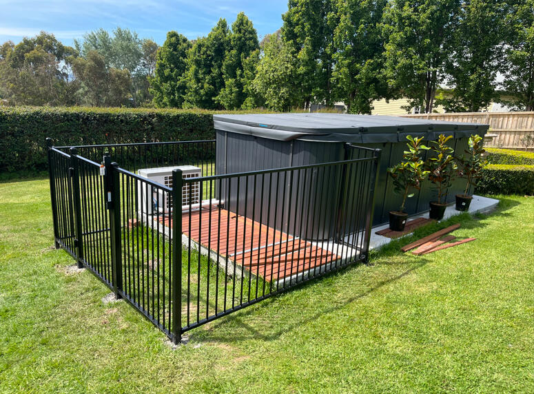 Pool fencing with child-safe gate and installed around a spa in Drouin. Custom pool and spa fencing completed in Drouin featuring child-safe gate hardware and secure residential pool enclosure design.